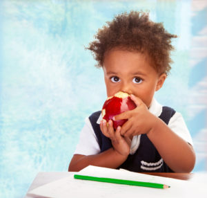 Young boy with apple. Mary Margaret St Louis Daycare