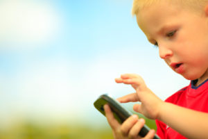image of a little boy using a smartphone