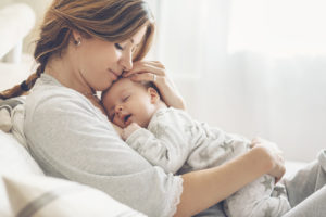 Tips to Help Your Newborn Sleep, mom with sleeping baby